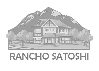 A black and white image of a house with mountains in the background.