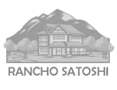 A black and white image of a house with mountains in the background.