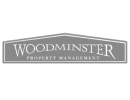 Woodminster property management logo.